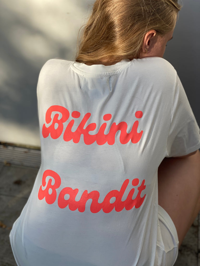 Oversized Bikini Bandit slogan T-shirt in cream with neon coral  font.