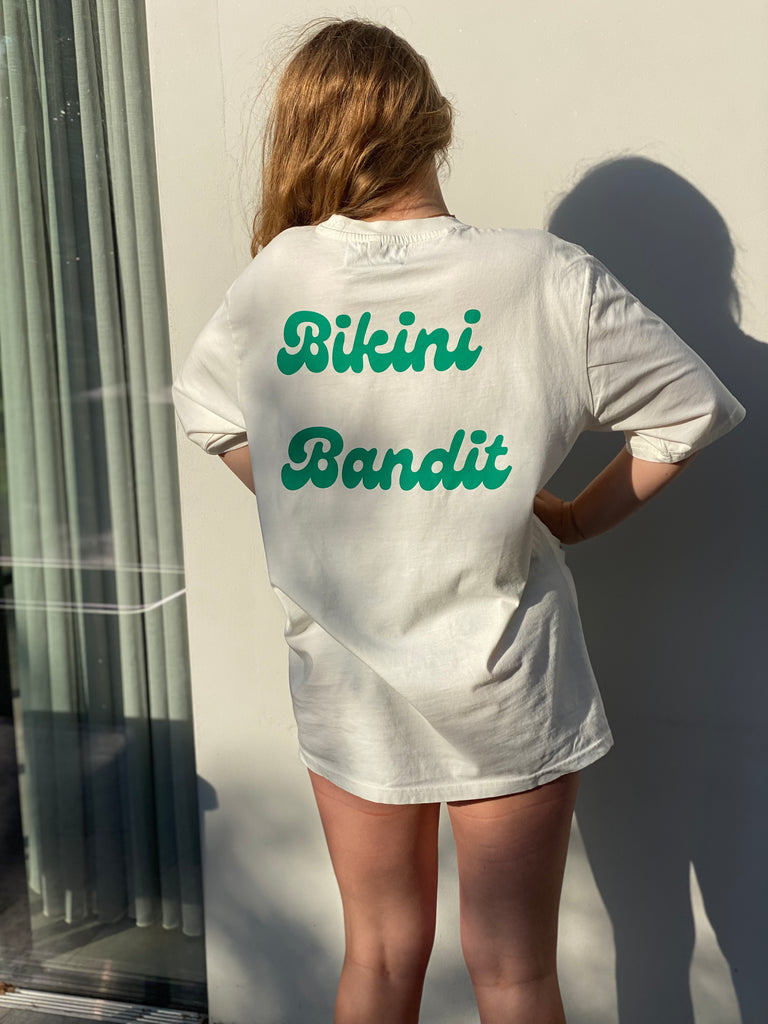 Oversized Bikini Bandit slogan T-shirt in cream with green font.