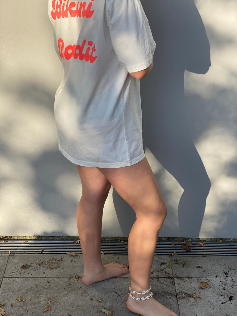 Oversized Bikini Bandit slogan T-shirt in stone wash white with neon coral  font.